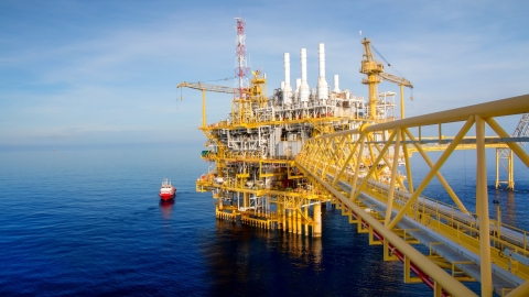 boat attending to offshore rig
